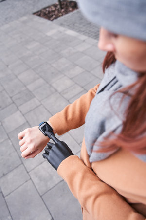 Female with prosthesis arm tracking time on smartwatch