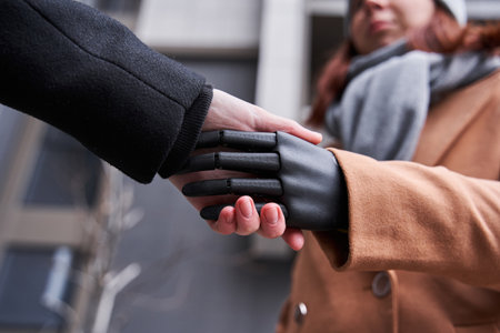 Woman with prosthesis arm greeting her friend
