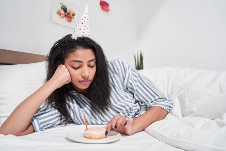 Woman staying alone at the self isolation at birthday partyの写真素材