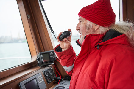 Senior man talking something at the walkie-talkieの写真素材