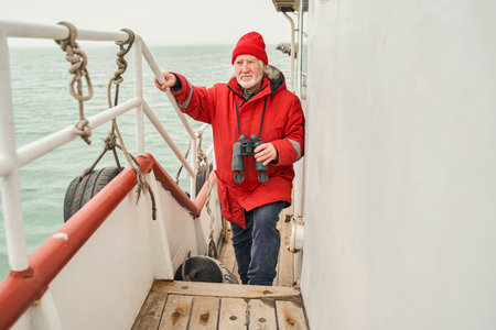 Fisherman walking through the boat while preparing to fishingの写真素材