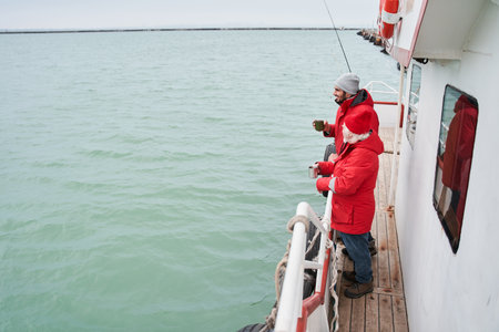 Senior bearded man looking at the water with his colleague