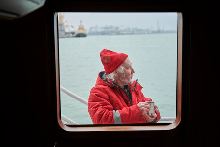 Fisherman standing at the boat and drinking hot teaの写真素材