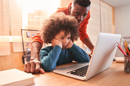 Man helping small child with study at home