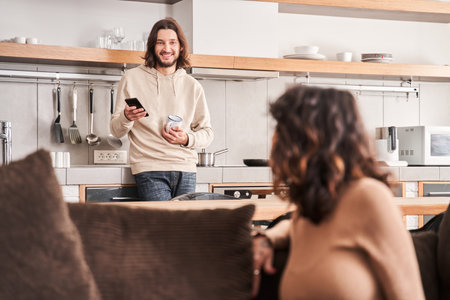 Couple spending time with gadgets at homeの写真素材