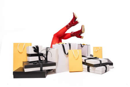 Woman laying at the floor around paper shopper bagsの写真素材