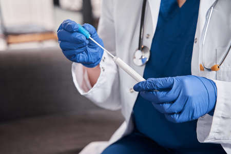 Doctor holding test stick for diagnostics coronavirus