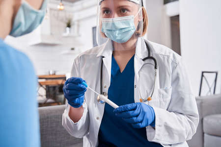 Doctor holding test stick for diagnostics coronavirusの写真素材