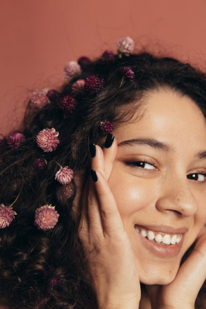 Girl touching face and laughing while looking to cameraの写真素材