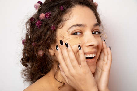 Curly girl rejoicing on white background