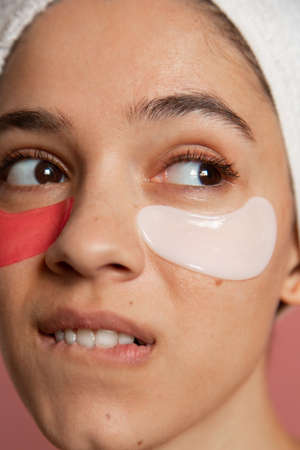 Woman biting her lips and looking sidewaysの写真素材