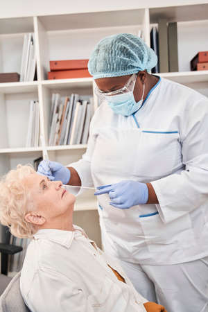 Nurse taking  virus or DNA test by nasal swab probe