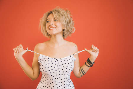 Woman touching shoulder straps of her dress