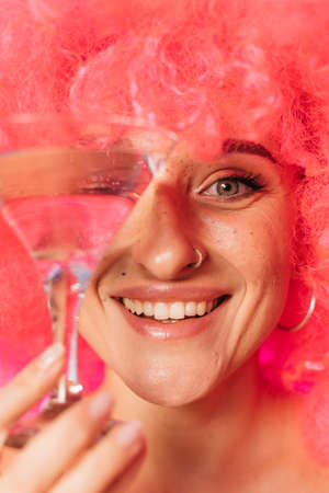 Woman holding glass with champagne and smilingの写真素材