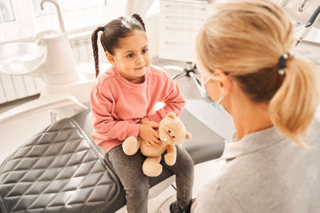 Doctor giving professional consultation to little patientの写真素材