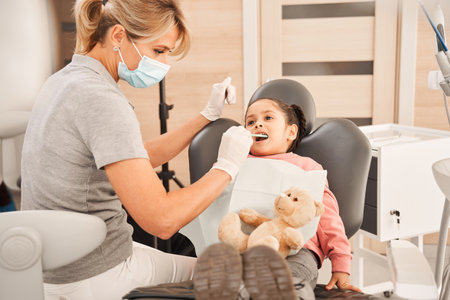 Child in the dental chair during treatmentの写真素材