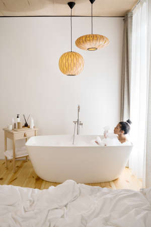 Woman taking a bath with a lot of foamの写真素材