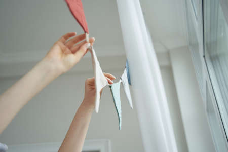 Female decorate apartment or home with flags