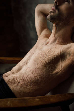 Cropped portrait of tranquil serene man leaned on armchairの写真素材