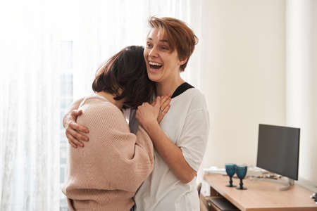 Couple laughing with each other and showing true emotions while dancingの写真素材