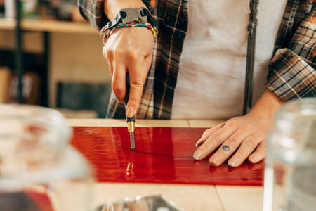 Woman creates a new collection of mosaik, while working with glassの写真素材