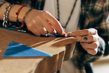 Artist preparing her new mosaic while working at the showroom at the tableの写真素材