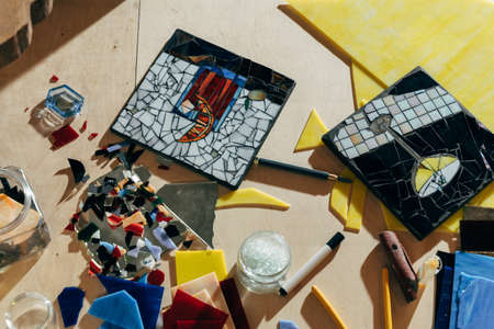 Designer working of new mosaics while spending time at her modern studio