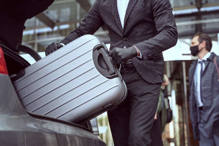 Use of disposable gloves while handling luggage helps maintain cleanlinessの写真素材