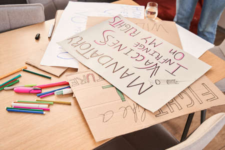 View of the wooden table with cupboard handmade posters about feminismの写真素材
