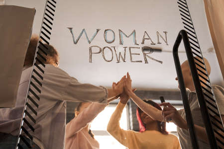 Girls giving high five greet to each other and showing unity friendshipの写真素材