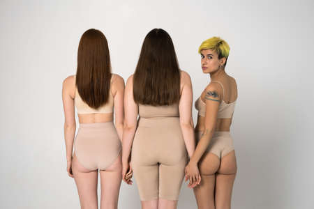 Back view of the three different girls posing at the studio
