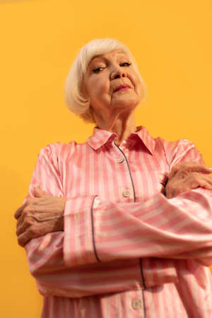 Lady standing calm and confident and looking self assuredの写真素材