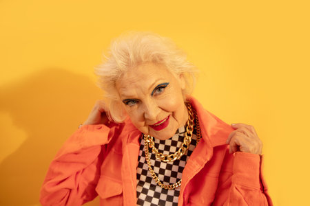 Grandmother wearing fashionable clothes looking at the camera
