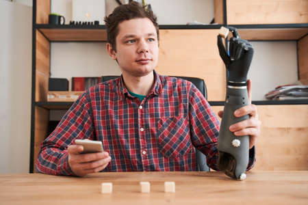 Engineer taking a little cubes with the bionic hand while testing functionality