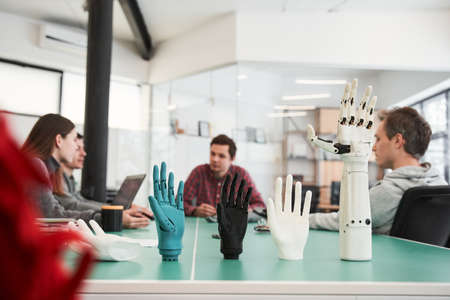 Workers helping each other to adjust quality of manufacturing elementsの写真素材