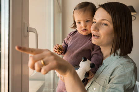 Girl with down syndrome holding cookie and looking at the window