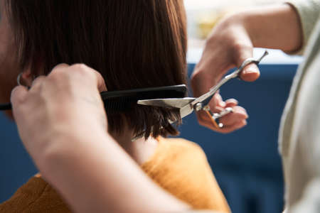 Couple having hair cut at home during quarantine coronavirus pandemicの写真素材