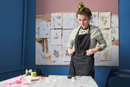 Woman preparing to the tattoo session at her kitchen