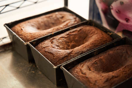 Bakeware with fresh cakes standing at the table and preparing for the salling