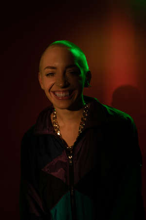 Blonde girl sharing wide happy smile while enjoying posing at the studioの写真素材