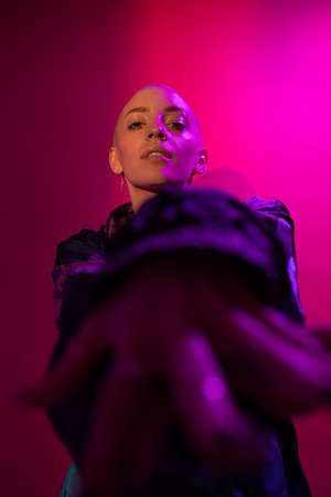 Woman looking at the camera and posing at the studio during the shooting