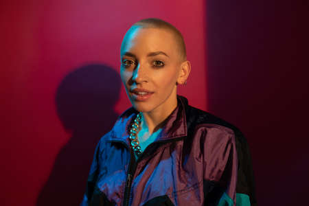 Woman with makeup and short hair in fashionable clothes looking at the cameraの写真素材