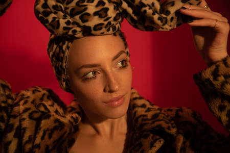 Woman with nude makeup wearing total leopard look gazed awayの写真素材