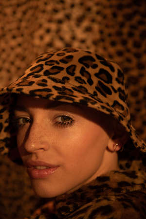 Girl wearing leopard panama posing while looking at the cameraの写真素材