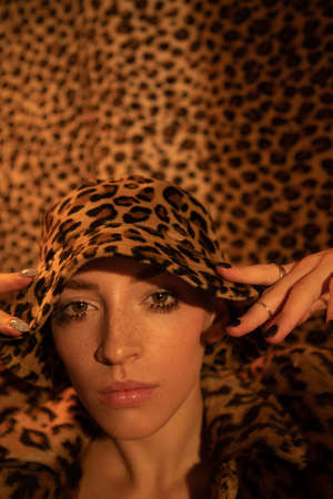 Woman wearing total leopard look looking to the camera at the studioの写真素材