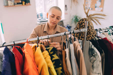 Short haired woman parsing the wardrobe while spending time at homeの写真素材