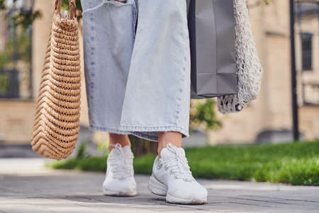 Girl walking with shopping bagsの写真素材