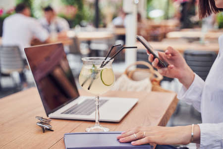 Cropped shot of business woman drinking cocktailの写真素材