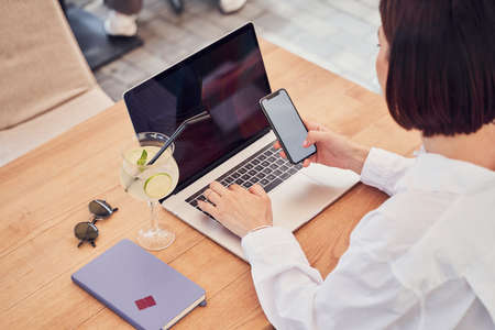 Top view of businesswoman making notes in notebookの写真素材