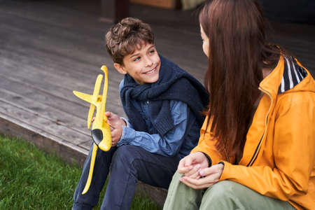 Cheerful boy spending time with mother outdoors